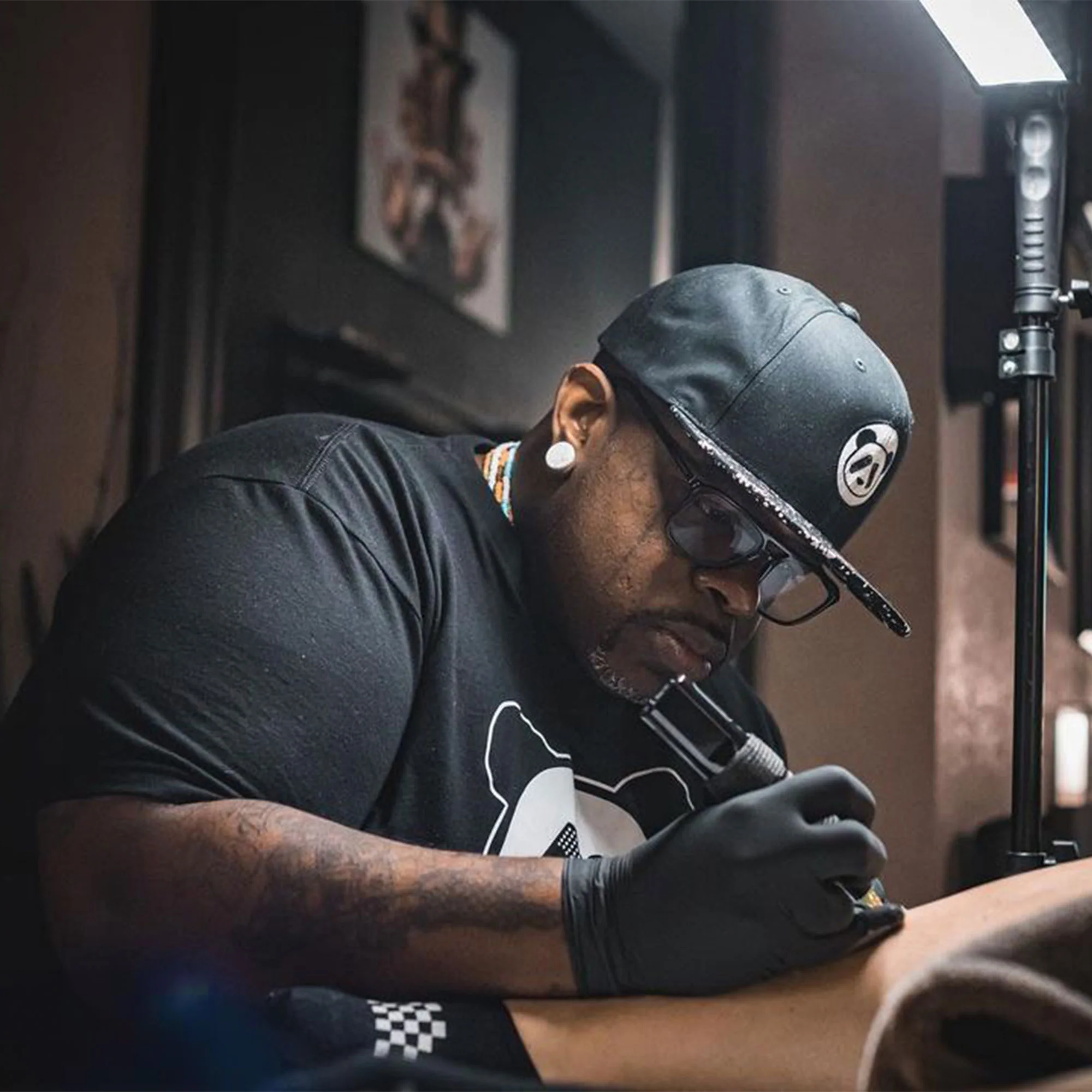 Edward ‘Poch’ Best concentrating on a tattoo in his studio